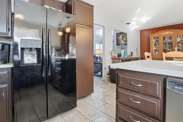 a kitchen with a refrigerator and a sink