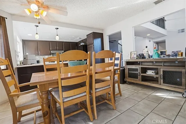 a view of a dining room with furniture and a chandelier
