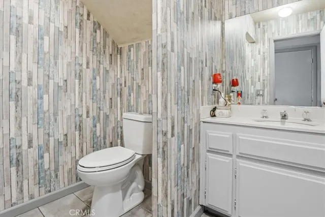 a bathroom with a toilet sink and shower curtain