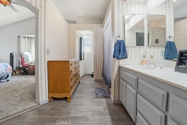 a bathroom with a sink vanity and mirror