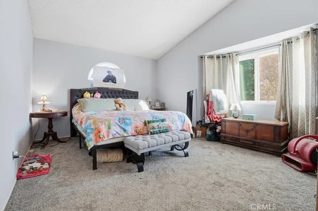 a bedroom with bed and a couch