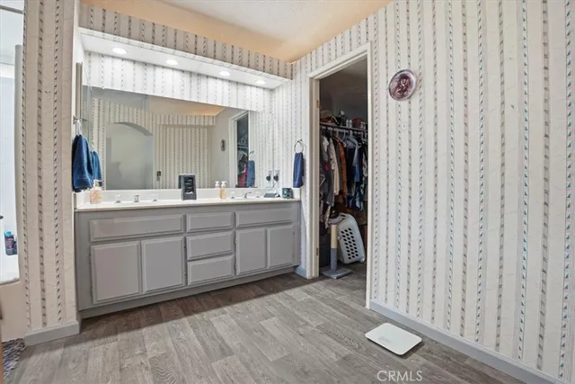 a spacious bathroom with a double vanity sink and a mirror