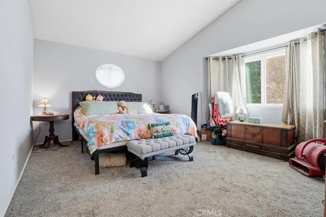a bedroom with bed and a chandelier