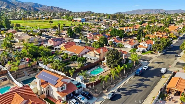 an aerial view of residential houses with outdoor space and swimming pool