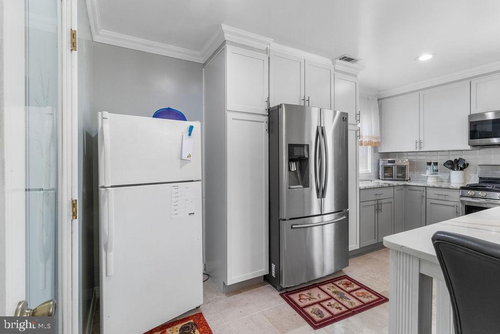 607 Valley Brook Drive Silver Spring, MD 20904 - Photo 11 of 67 a white refrigerator freezer and a stove in a kitchen
