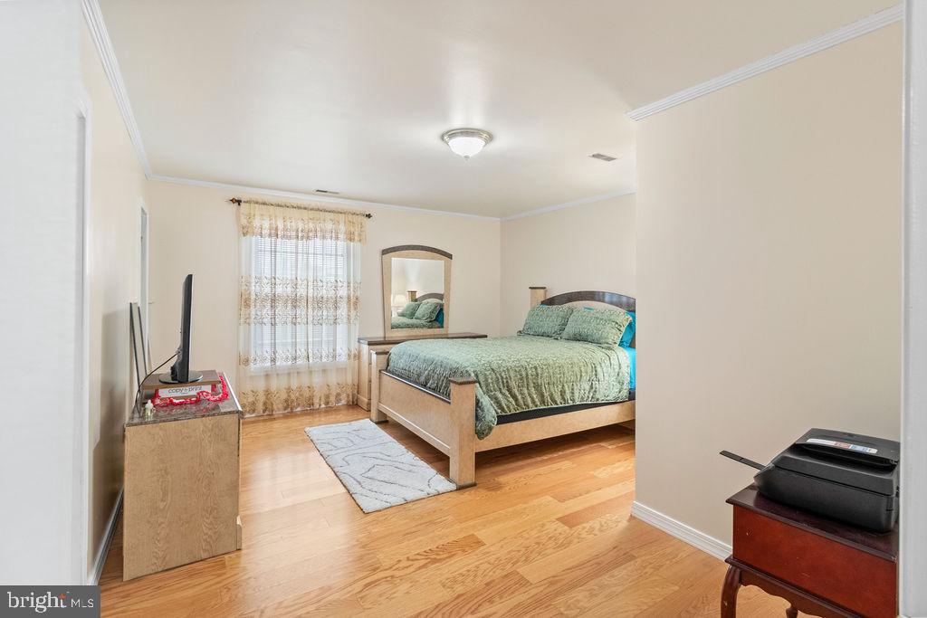 607 Valley Brook Drive Silver Spring, MD 20904 - Photo 26 of 67 a bedroom with a bed and a window