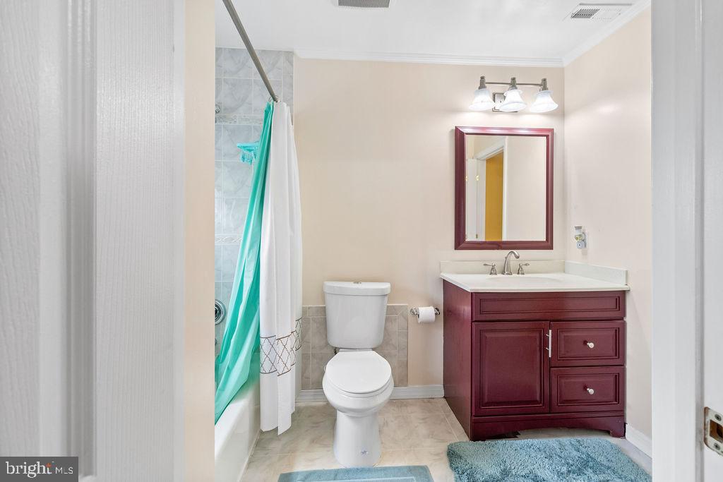 607 Valley Brook Drive Silver Spring, MD 20904 - Photo 29 of 67 a bathroom with a toilet a sink and a mirror