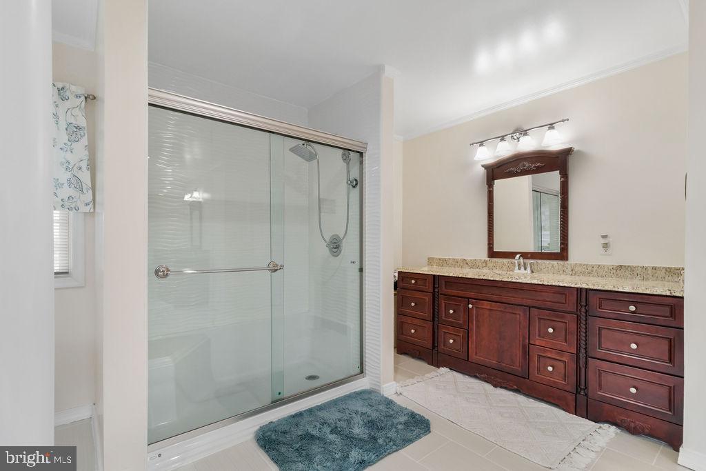 607 Valley Brook Drive Silver Spring, MD 20904 - Photo 35 of 67 a bathroom with a granite countertop sink mirror and shower