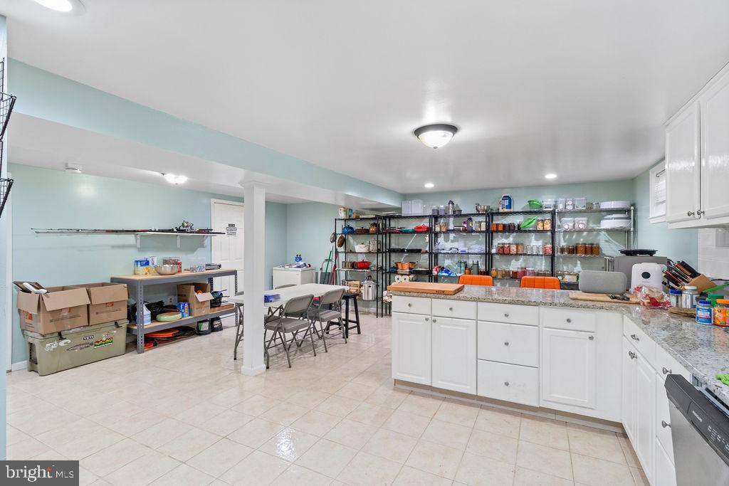 607 Valley Brook Drive Silver Spring, MD 20904 - Photo 50 of 67 a room with lots of wooden furniture and a view of kitchen