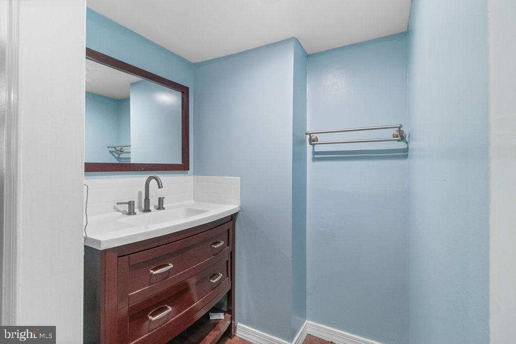 607 Valley Brook Drive Silver Spring, MD 20904 - Photo 56 of 67 a bathroom with a sink a toilet and mirror