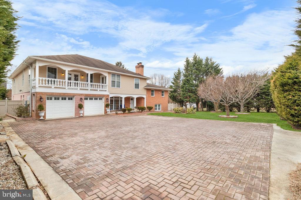 607 Valley Brook Drive Silver Spring, MD 20904 - Photo 66 of 67 a front view of a house with a garden and trees