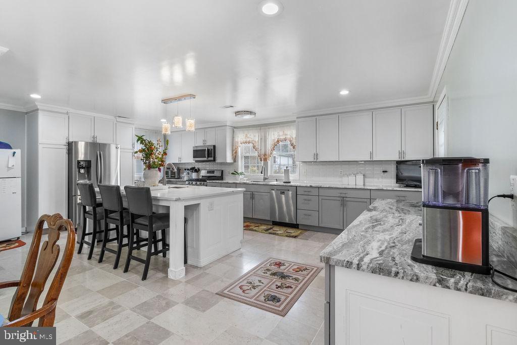 607 Valley Brook Drive Silver Spring, MD 20904 - Photo 8 of 67 a kitchen with stainless steel appliances granite countertop a stove top oven a sink refrigerator and cabinets