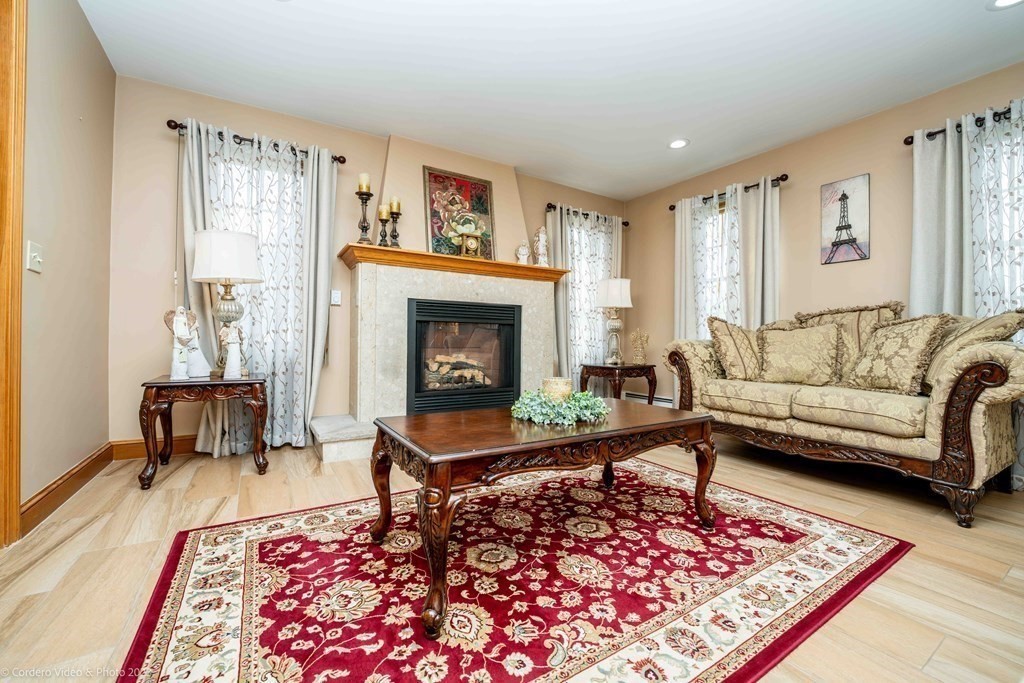 27 Peach Blossom Road Acushnet, MA 02743 - Photo 12 of 42 a living room with furniture and a fireplace