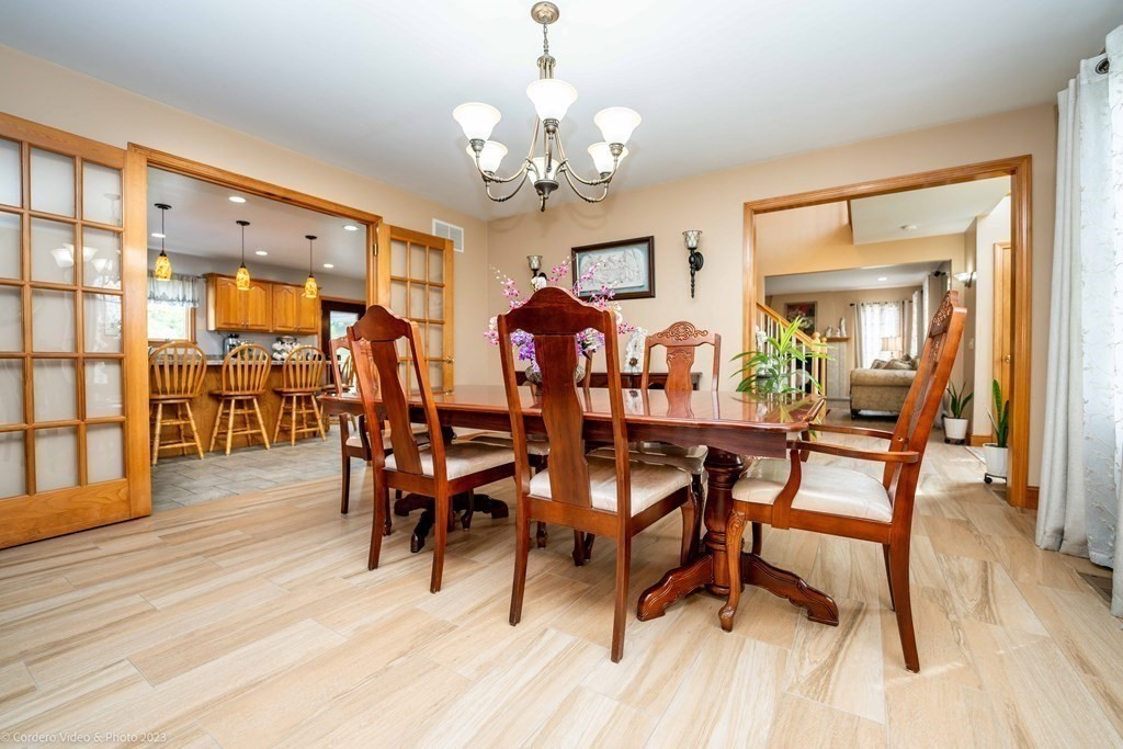 27 Peach Blossom Road Acushnet, MA 02743 - Photo 15 of 42 a view of a dining room with furniture and wooden floor
