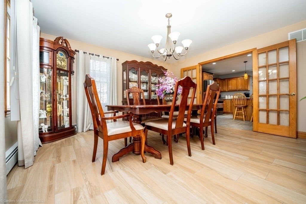 27 Peach Blossom Road Acushnet, MA 02743 - Photo 16 of 42 a view of a dining room with furniture and wooden floor