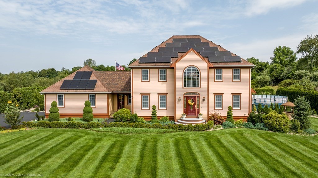 27 Peach Blossom Road Acushnet, MA 02743 - Photo 2 of 42 front view of a house with a yard