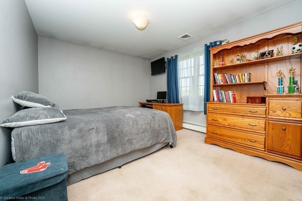 27 Peach Blossom Road Acushnet, MA 02743 - Photo 23 of 42 a bedroom with a bed and a dresser