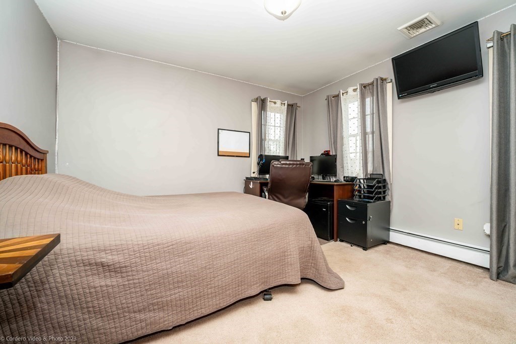 27 Peach Blossom Road Acushnet, MA 02743 - Photo 24 of 42 a bedroom with a bed and wooden floor