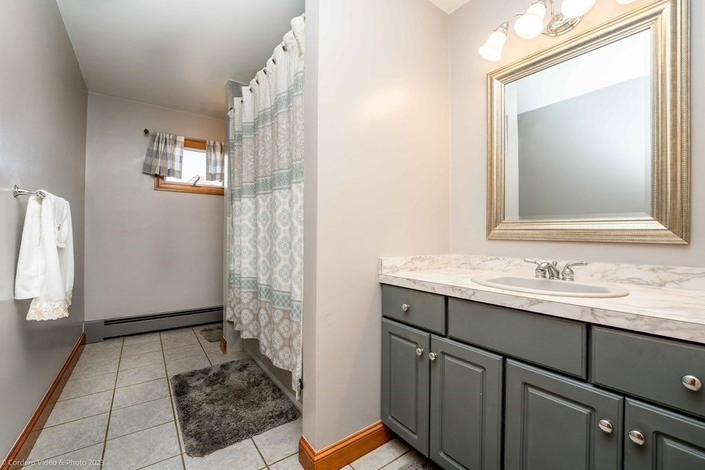 27 Peach Blossom Road Acushnet, MA 02743 - Photo 25 of 42 a bathroom with a sink a mirror and a shower