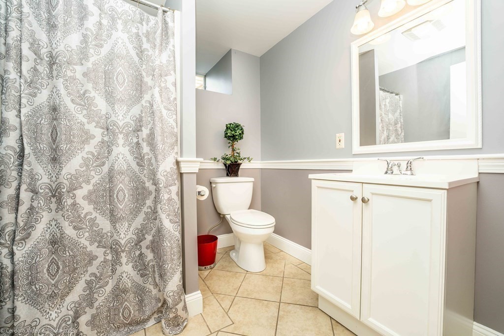 27 Peach Blossom Road Acushnet, MA 02743 - Photo 27 of 42 a bathroom with a toilet sink and mirror