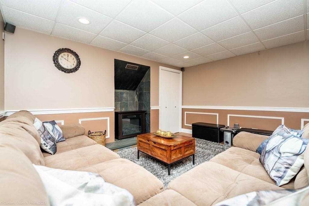 27 Peach Blossom Road Acushnet, MA 02743 - Photo 29 of 42 a living room with furniture and a fireplace