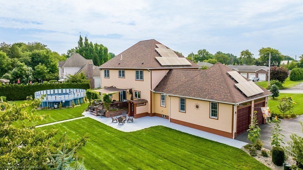 27 Peach Blossom Road Acushnet, MA 02743 - Photo 38 of 42 a aerial view of a house with table and chairs with wooden fence