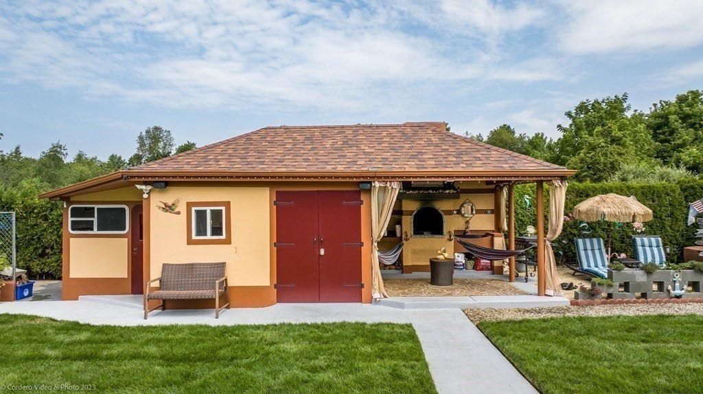 27 Peach Blossom Road Acushnet, MA 02743 - Photo 41 of 42 a view of a house with a yard potted plants and a chair