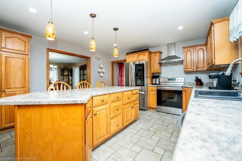 27 Peach Blossom Road Acushnet, MA 02743 - Photo 6 of 42 a large kitchen with granite countertop a sink and white cabinets