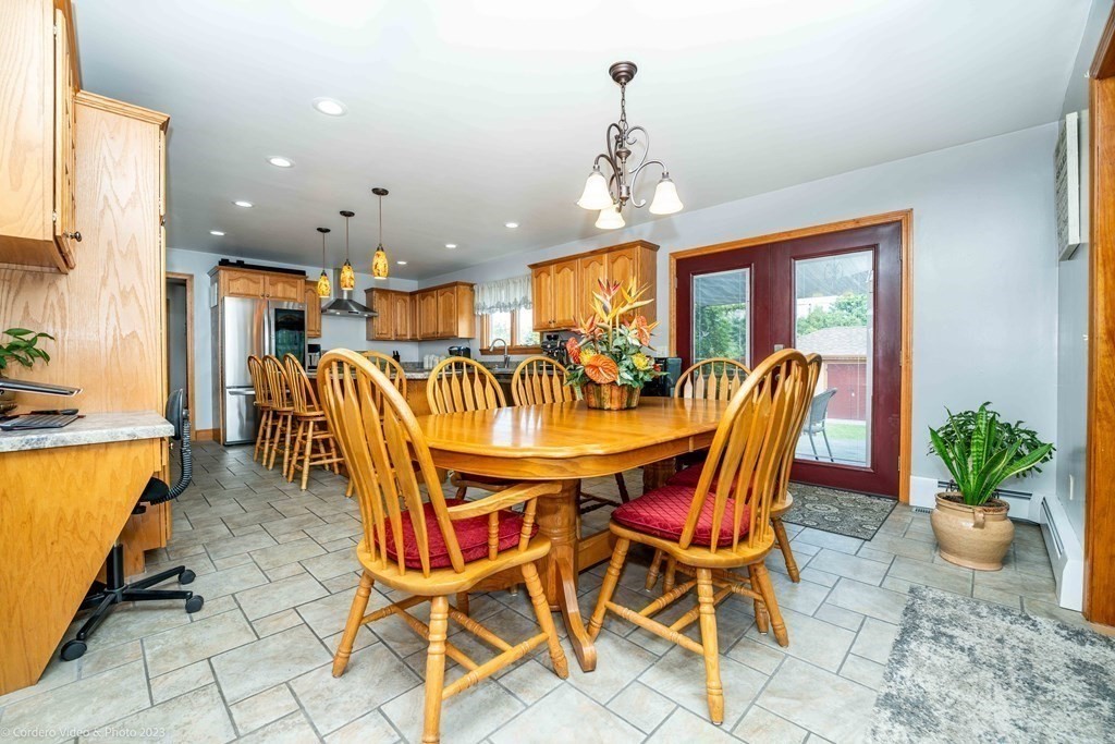 27 Peach Blossom Road Acushnet, MA 02743 - Photo 7 of 42 a view of a dining room with furniture a chandelier and a window