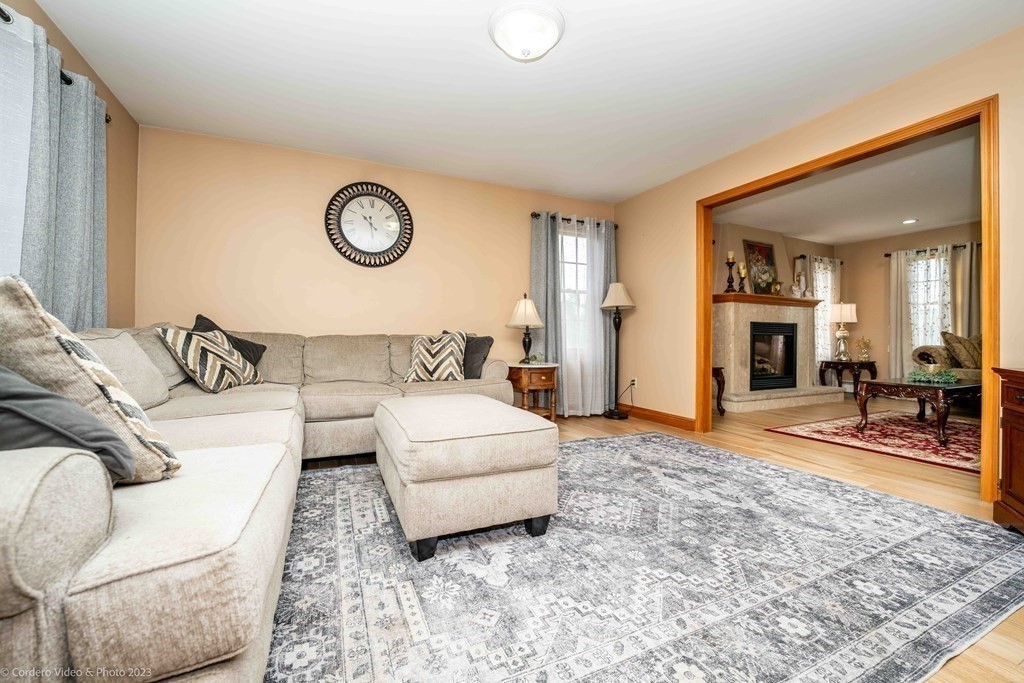 27 Peach Blossom Road Acushnet, MA 02743 - Photo 10 of 42 a living room with a couch and a table with wooden floor