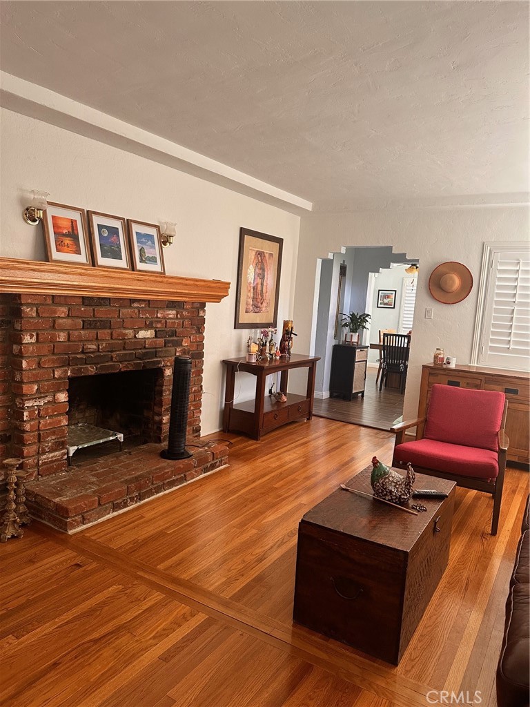 18090 Iris Avenue Riverside, CA 92508 - Photo 14 of 49 a living room with furniture a fireplace and wooden floor