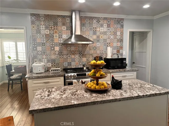 a kitchen with a stove a sink and a microwave