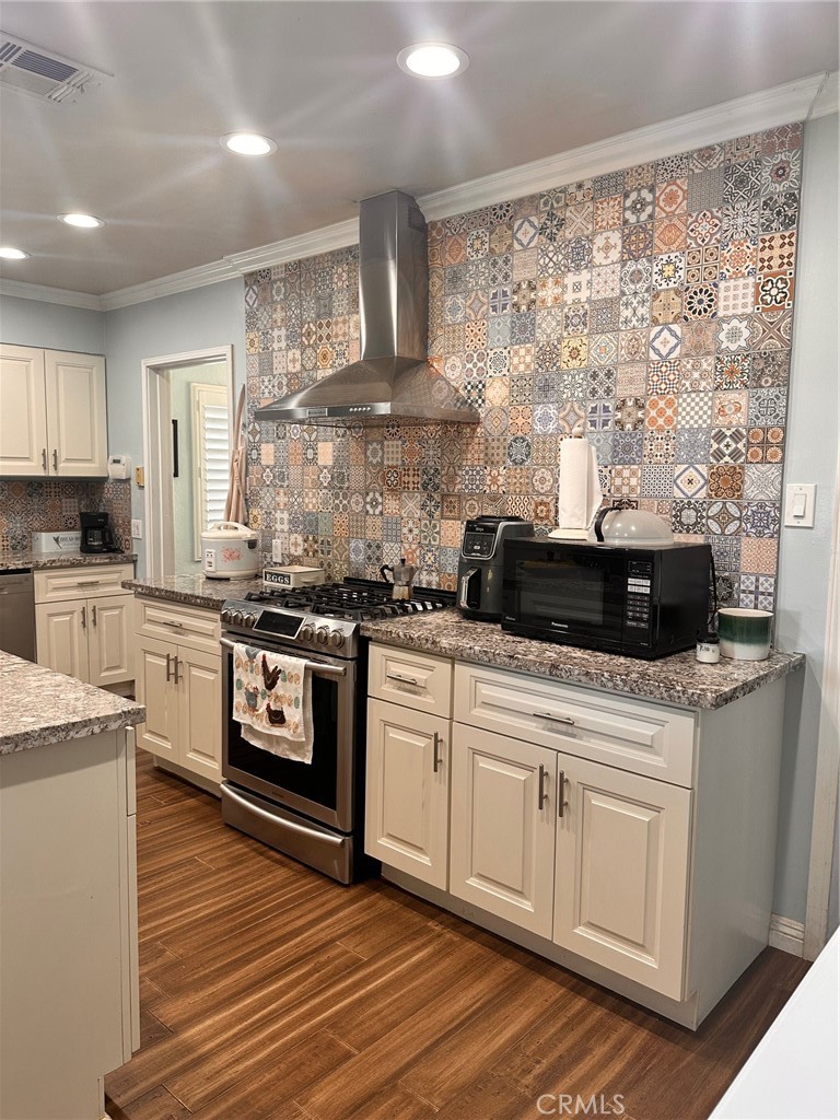 18090 Iris Avenue Riverside, CA 92508 - Photo 20 of 49 a kitchen with a stove a sink and a microwave