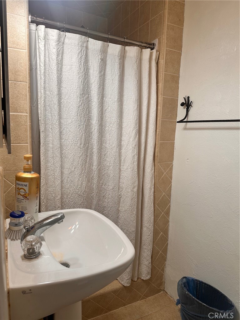 18090 Iris Avenue Riverside, CA 92508 - Photo 30 of 49 a bathroom with a sink and a mirror