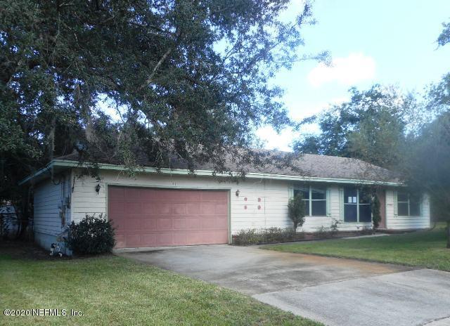 411 Gentian Road St. Augustine, FL 32086 - Photo 1 of 6 a front view of a house with a garden and yard