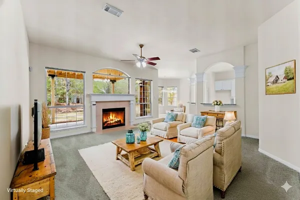 an empty room with windows and fireplace
