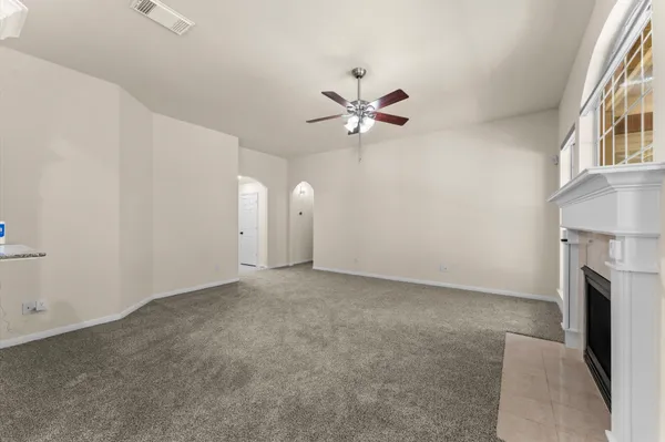 a kitchen with white cabinets and appliances