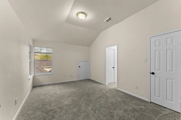 a living room with furniture a flat screen tv and a window