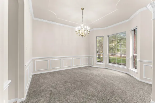 a living room with furniture a fireplace and a large window