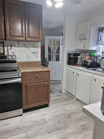 a kitchen with granite countertop cabinets and steel stainless steel appliances