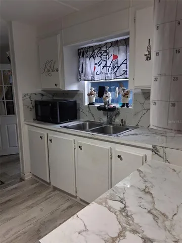 a kitchen with stainless steel appliances a sink and a refrigerator