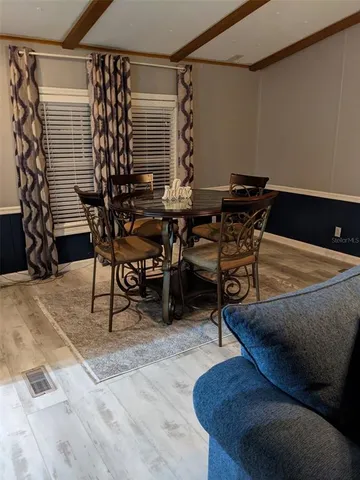 a dining room with furniture and wooden floor