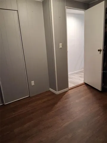 an empty room with wooden floor