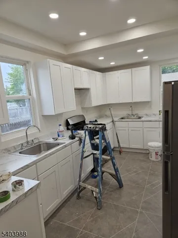 a kitchen with a sink a window and stainless steel appliances