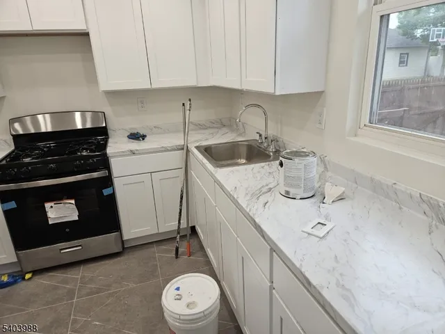 a kitchen with a sink stove and cabinets