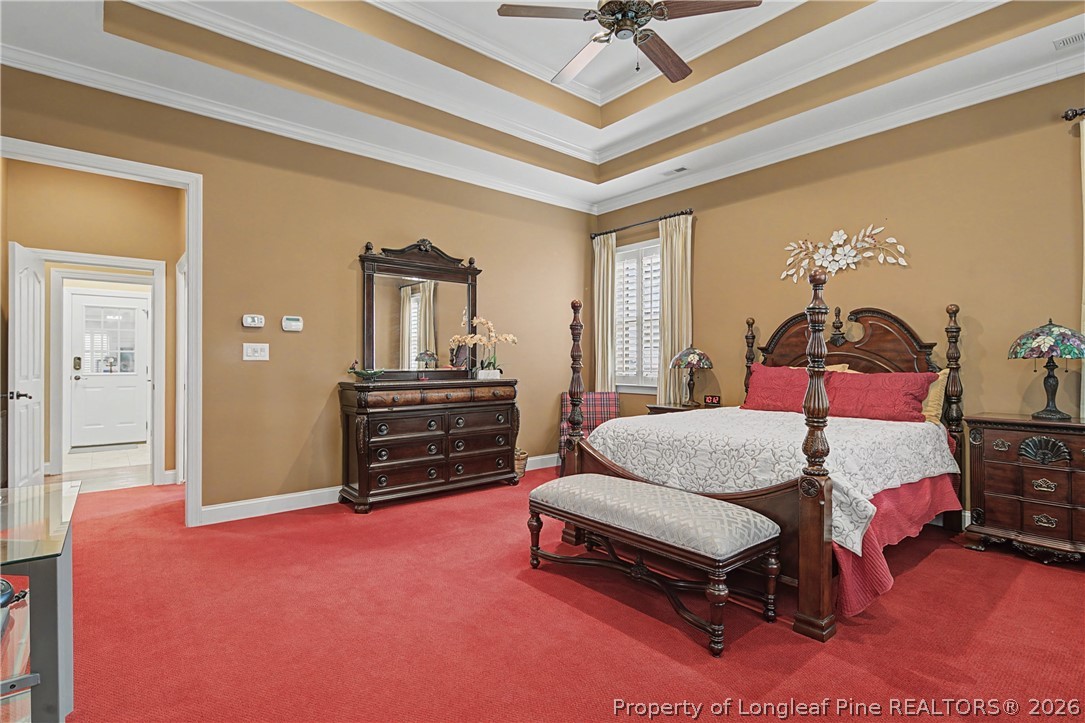 115 Micahs Way North Spring Lake, NC 28390 - Photo 23 of 39 a bedroom with a bed and a chandelier