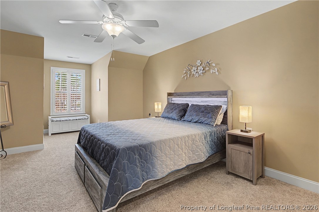 115 Micahs Way North Spring Lake, NC 28390 - Photo 31 of 39 a bedroom with a bed and a chandelier