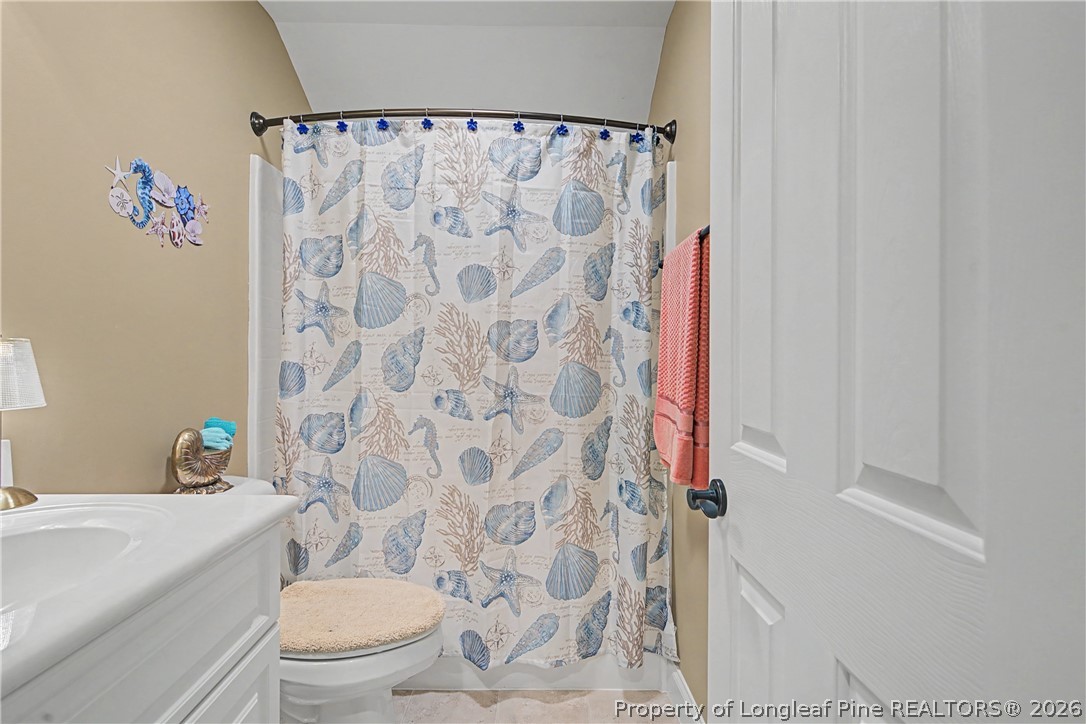 115 Micahs Way North Spring Lake, NC 28390 - Photo 36 of 39 a white toilet sitting next to a shower curtain