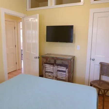 a bedroom with a bed and a television