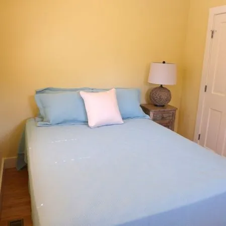 a bedroom with a bed and a night stand